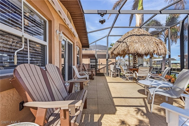 view of patio / terrace featuring glass enclosure