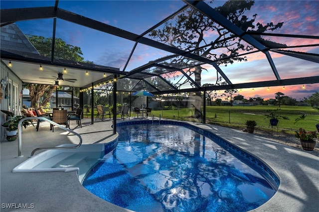 pool at dusk featuring glass enclosure and a patio