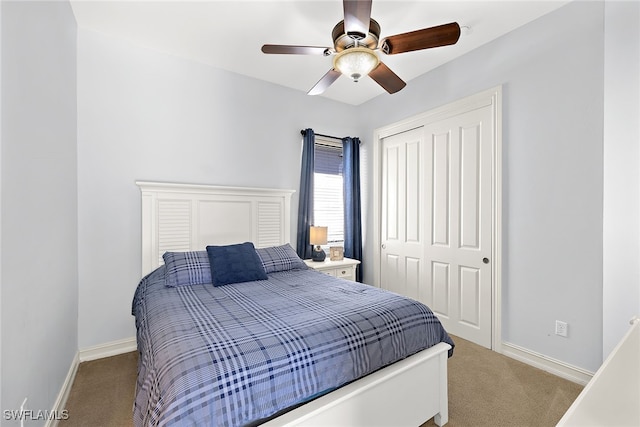 carpeted bedroom with a closet and ceiling fan