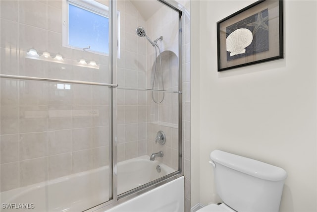 bathroom featuring toilet and enclosed tub / shower combo