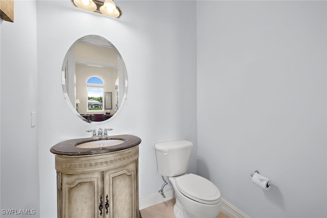 bathroom featuring vanity, tile patterned floors, and toilet