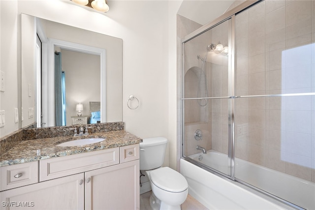 full bathroom with enclosed tub / shower combo, toilet, and vanity