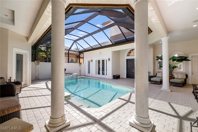 view of pool with a lanai, french doors, and a patio