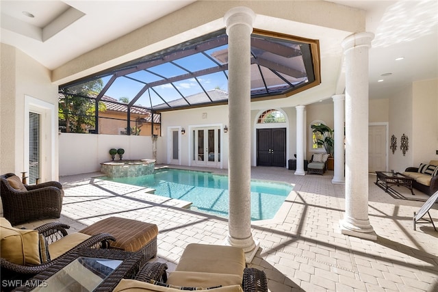 view of swimming pool with a lanai, french doors, a patio, and an outdoor living space