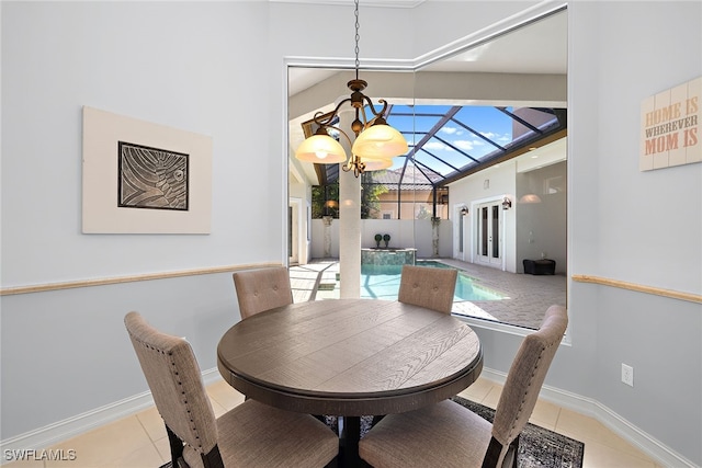 dining space with a notable chandelier, light tile patterned floors, and lofted ceiling