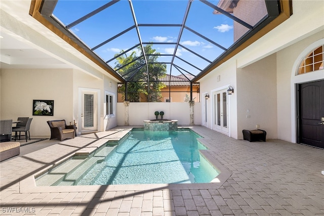 view of swimming pool featuring a patio, glass enclosure, french doors, and an in ground hot tub