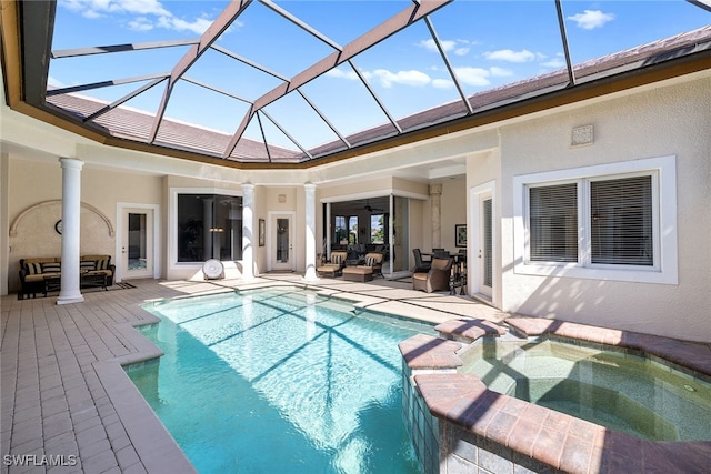 view of swimming pool with an outdoor hangout area, glass enclosure, an in ground hot tub, a patio area, and ceiling fan