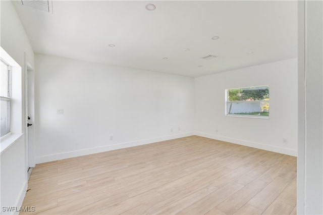 unfurnished room with light hardwood / wood-style flooring