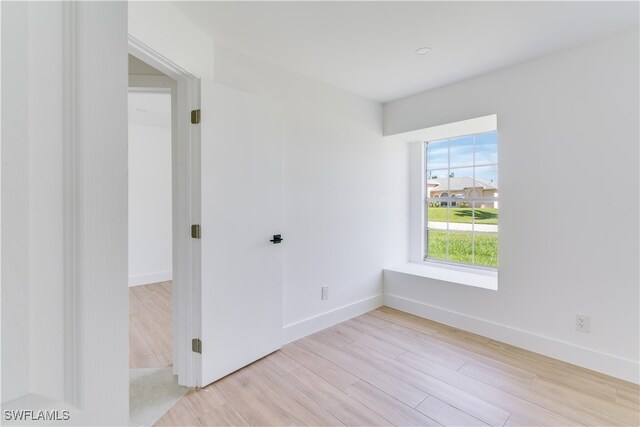 spare room featuring light wood-type flooring