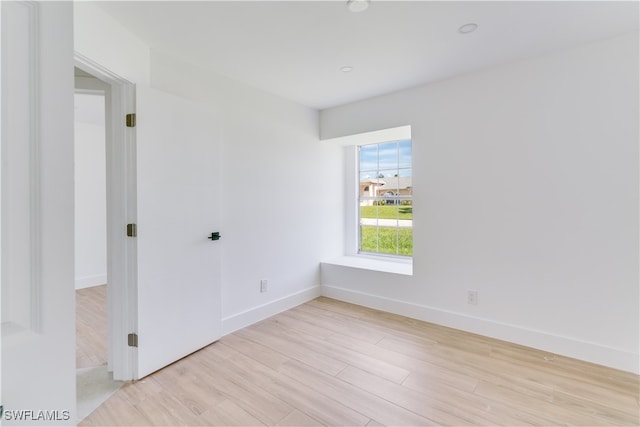 empty room with light hardwood / wood-style floors