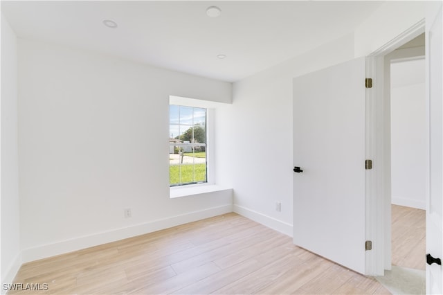 spare room featuring light wood-type flooring