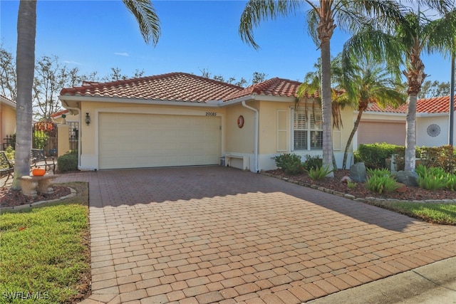 mediterranean / spanish-style house with a garage