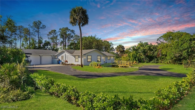 view of front of house featuring a lawn and a garage