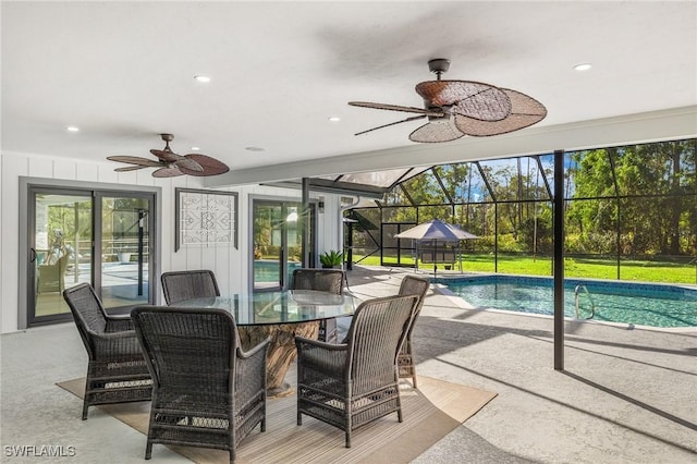 interior space with ceiling fan and glass enclosure