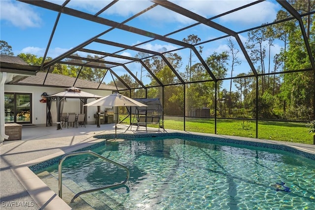 view of pool featuring a patio, a gazebo, glass enclosure, and a lawn