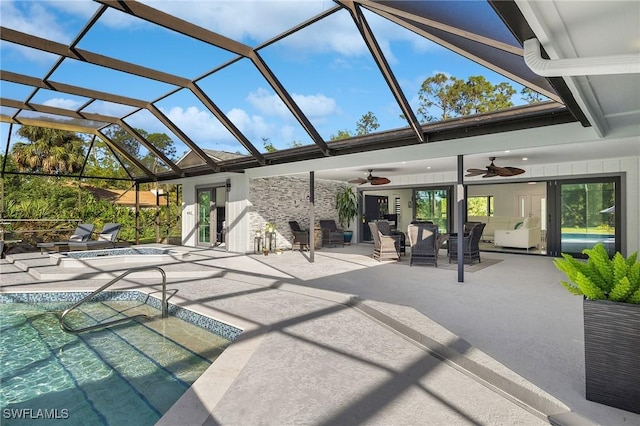 view of patio with ceiling fan and glass enclosure