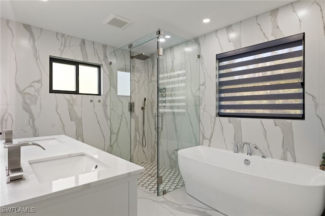 bathroom featuring vanity and shower with separate bathtub