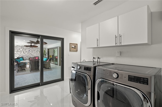 washroom with ceiling fan, cabinets, and washer and dryer