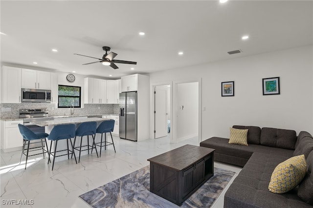 living room featuring sink and ceiling fan