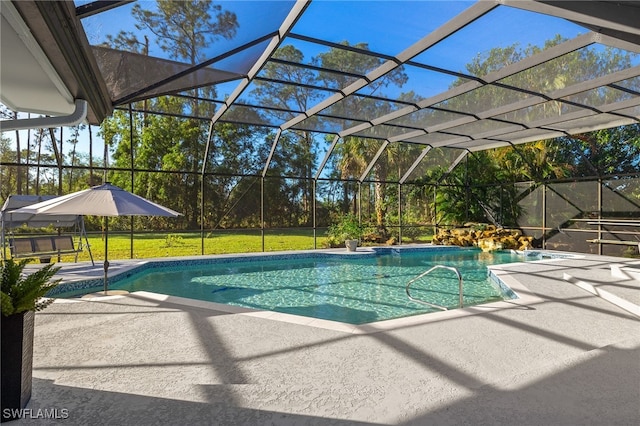 view of swimming pool featuring a yard, a lanai, and a patio