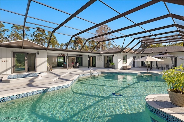 view of pool featuring a patio, a lanai, and ceiling fan