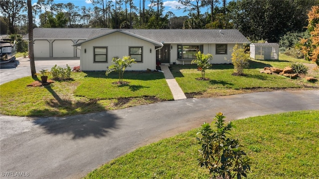 single story home with a garage and a front yard