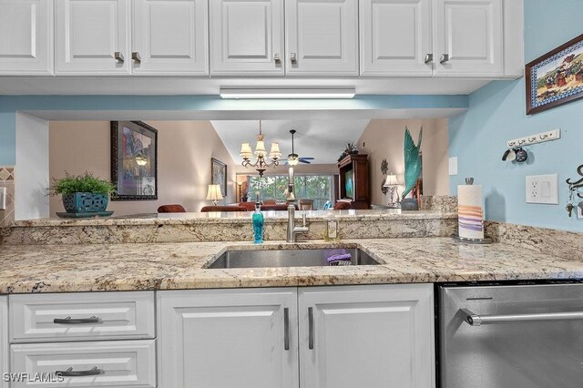 kitchen featuring dishwasher, ceiling fan with notable chandelier, white cabinetry, and sink