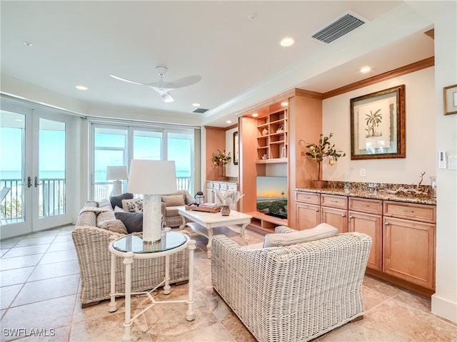 living room featuring french doors, ceiling fan, and ornamental molding