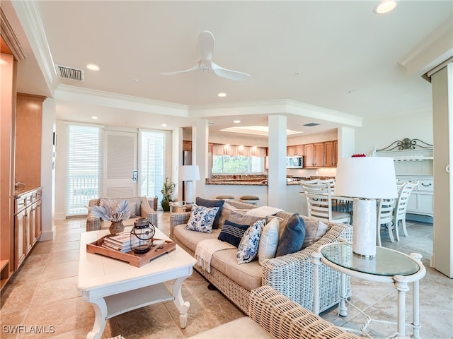 living room with ceiling fan and crown molding