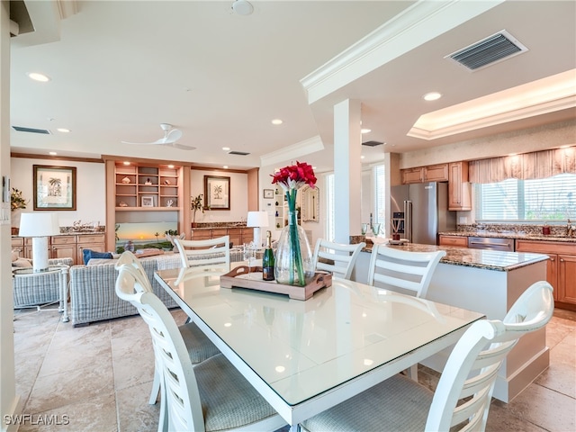 dining area featuring ceiling fan and crown molding