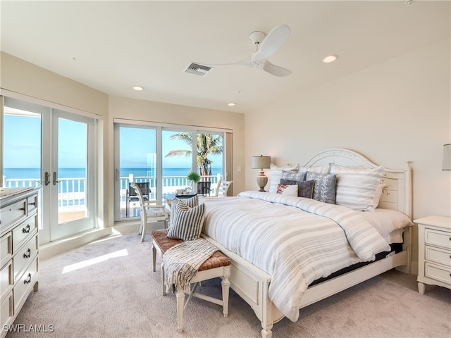 carpeted bedroom with ceiling fan, a water view, access to outside, and french doors