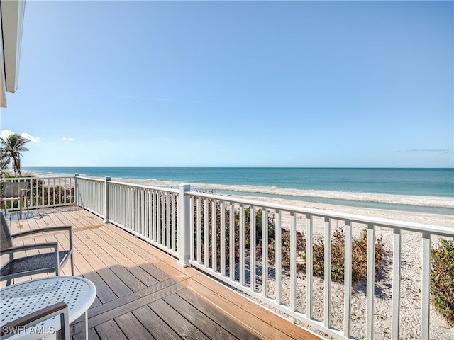 deck with a view of the beach and a water view