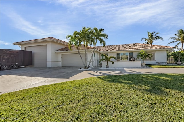 single story home with a garage and a front lawn