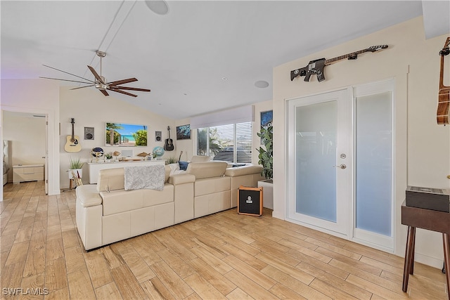 living room featuring light wood-type flooring, vaulted ceiling, and ceiling fan