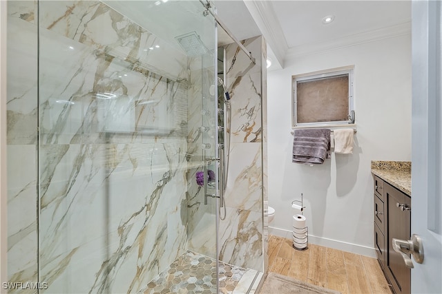 bathroom with vanity, toilet, ornamental molding, walk in shower, and wood-type flooring