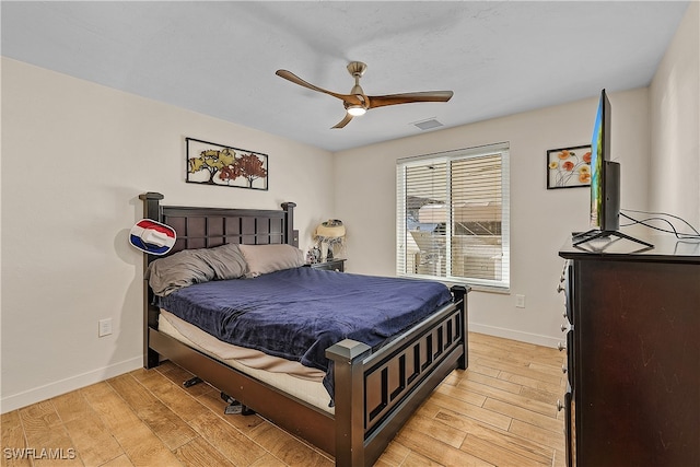 bedroom with ceiling fan and light hardwood / wood-style flooring