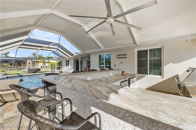 view of patio with glass enclosure and a bar