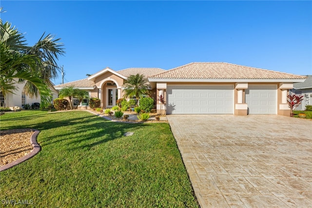 view of front of house with a front yard and a garage