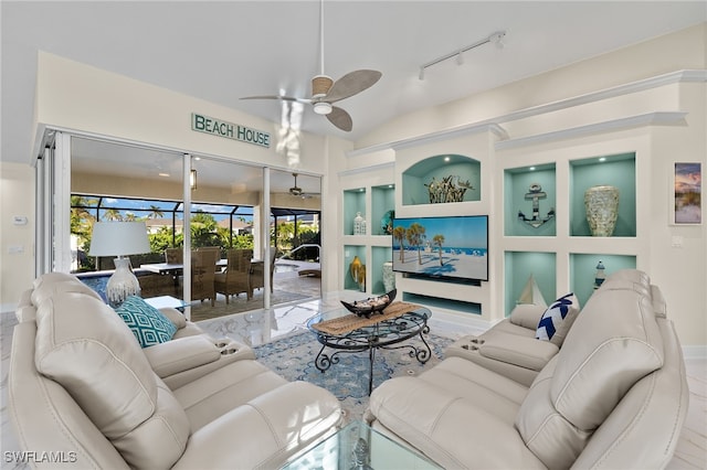 living room featuring built in shelves, ceiling fan, and lofted ceiling