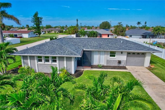 single story home featuring a garage and a front lawn