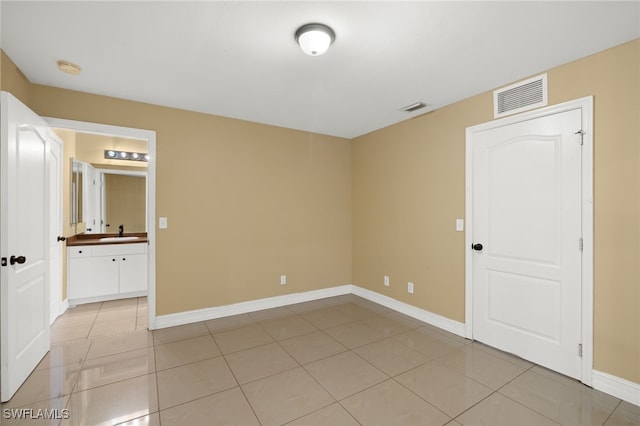 tiled spare room with sink