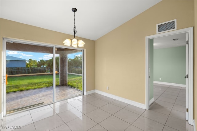 tiled empty room with a chandelier, a wealth of natural light, and vaulted ceiling