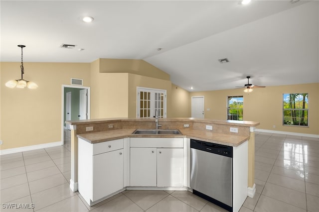 kitchen with hanging light fixtures, vaulted ceiling, stainless steel dishwasher, an island with sink, and white cabinetry