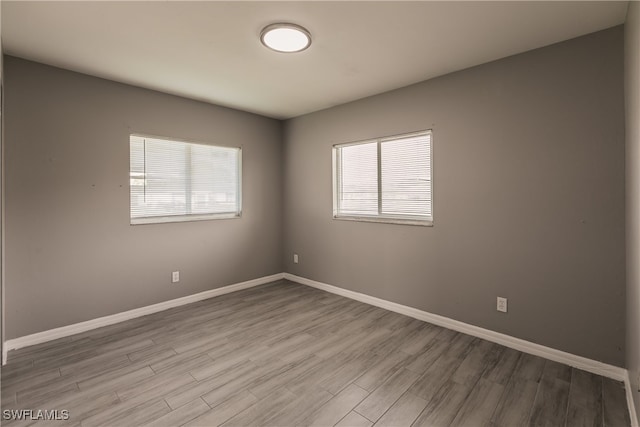 spare room with light wood-type flooring