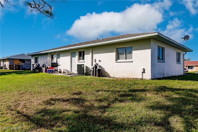 back of property featuring a lawn