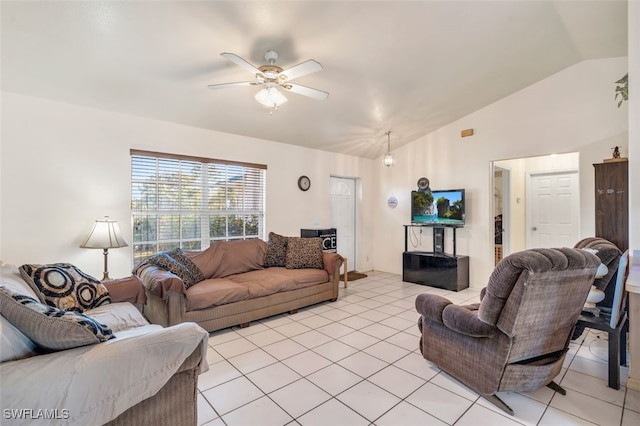 living room with ceiling fan, lofted ceiling, and light tile patterned flooring