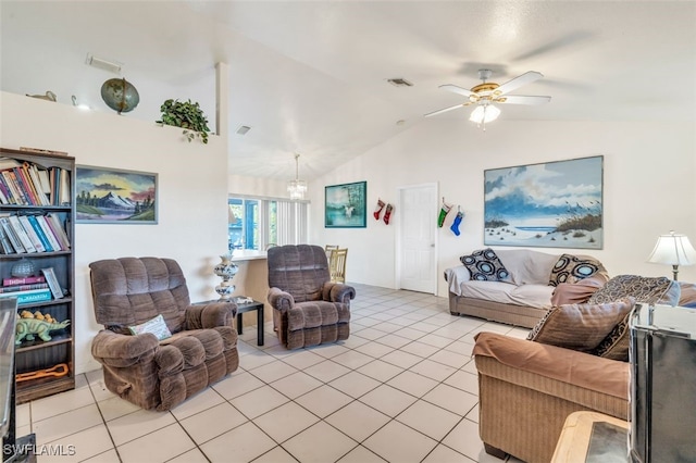 tiled living room with ceiling fan with notable chandelier and vaulted ceiling