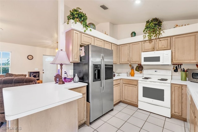 kitchen with light brown cabinets, kitchen peninsula, lofted ceiling, light tile patterned floors, and appliances with stainless steel finishes