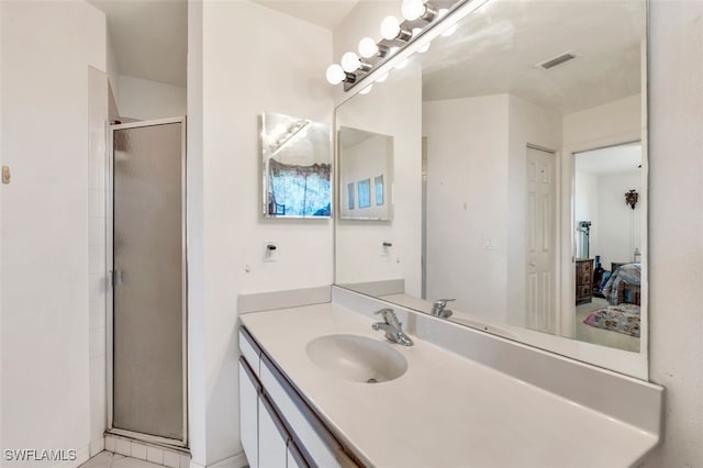 bathroom with vanity and a shower with shower door