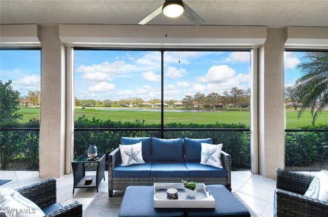 sunroom / solarium featuring ceiling fan